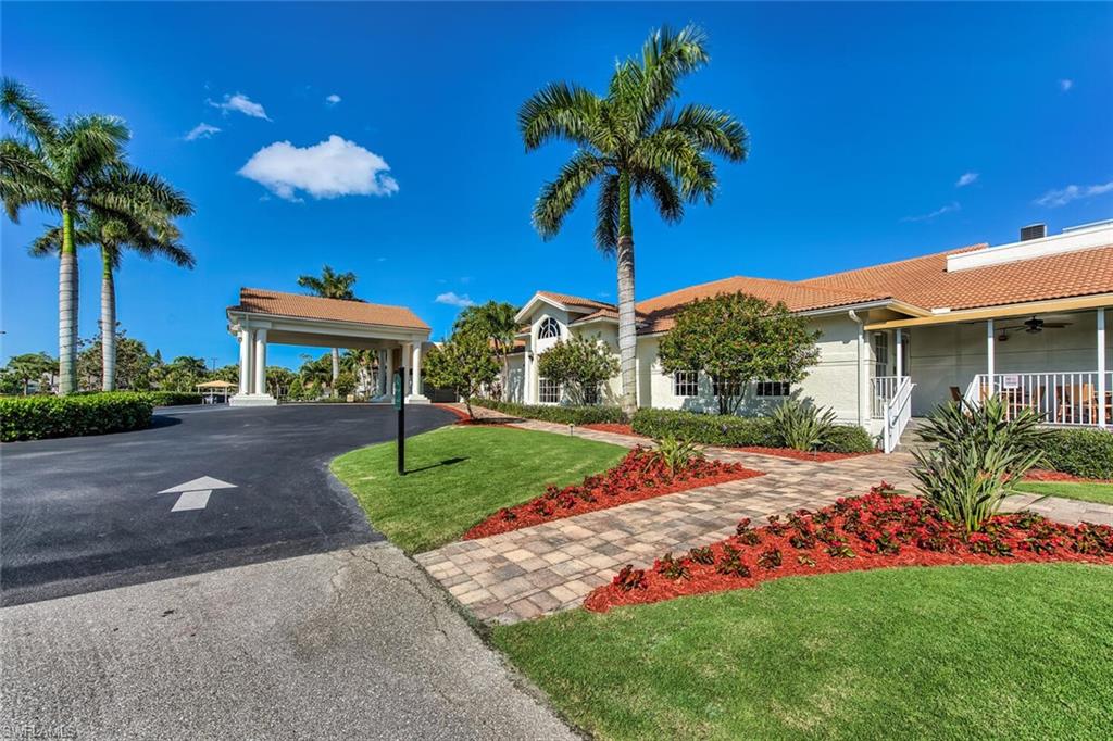 1100 Eastham Way, Unit A105 Naples, FL 34104 - Photo 25 of 27 a front view of a house with garden