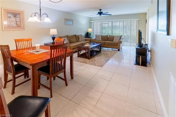 a living room with furniture a rug and a chandelier