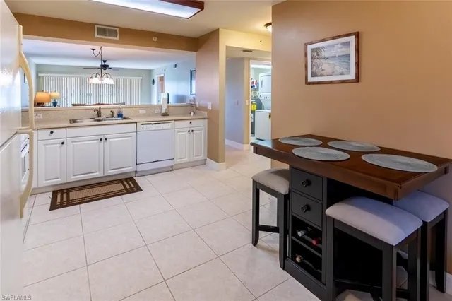 a kitchen with a sink cabinets and wooden floor