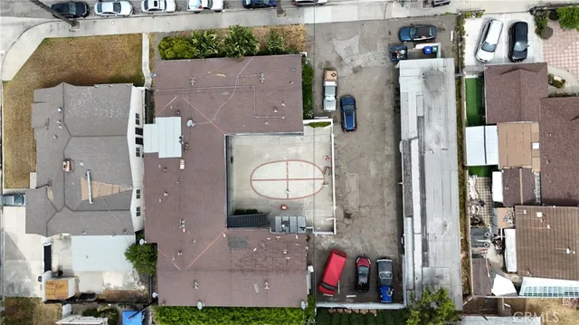 an aerial view of residential houses with outdoor space and parking