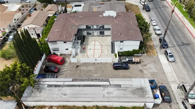 an aerial view of a house with a garden and parking space