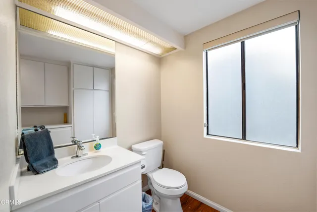 a bedroom with a bed wooden floor and window