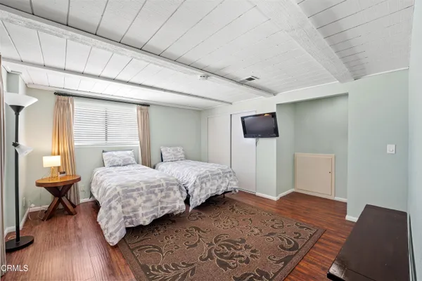 a bedroom with a bed and large window