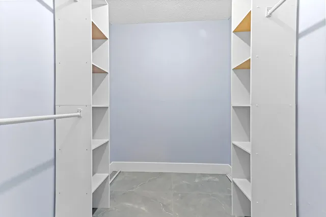 a bathroom with a toilet a sink a mirror and vanity