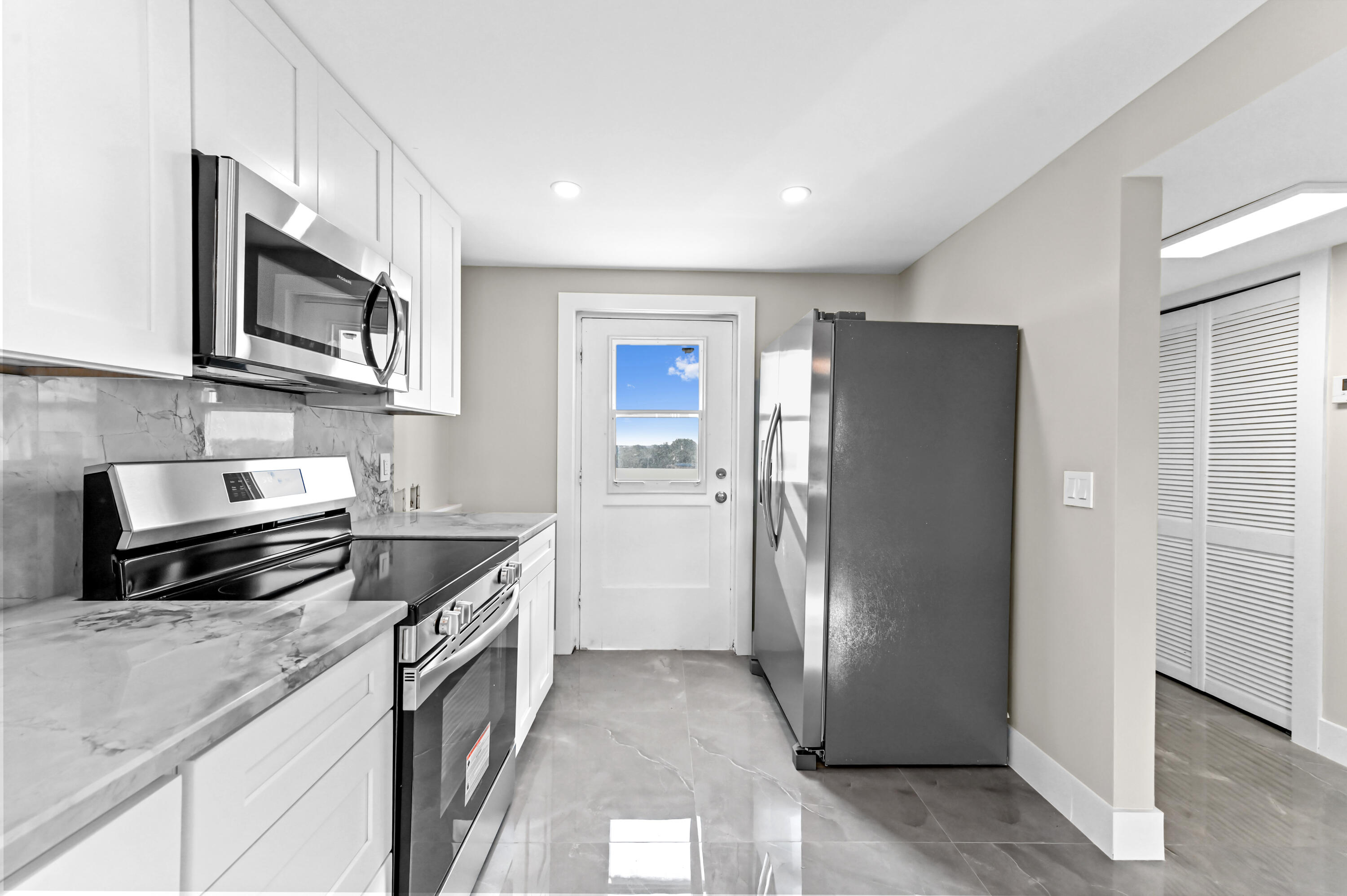 5500 Northwest 2nd Avenue, Unit 617 Boca Raton, FL 33487 - Photo 8 of 39 a kitchen with stainless steel appliances granite countertop a refrigerator and a stove top oven