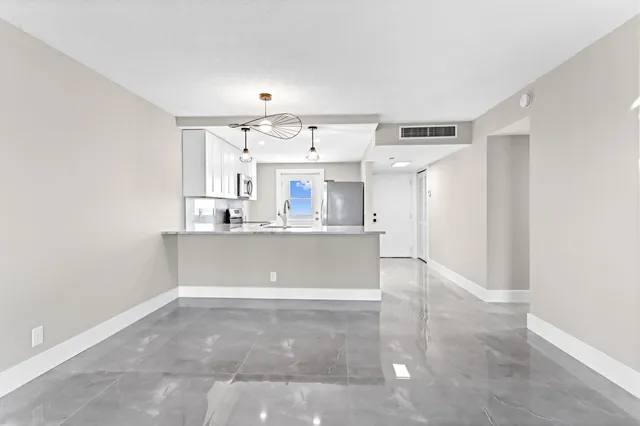 a view of kitchen with cabinets and wooden floor