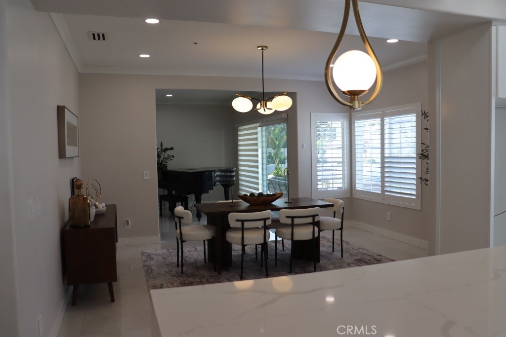9103 Wystone Avenue Northridge, CA 91324 - Photo 18 of 59 a view of a dining room with furniture and chandelier