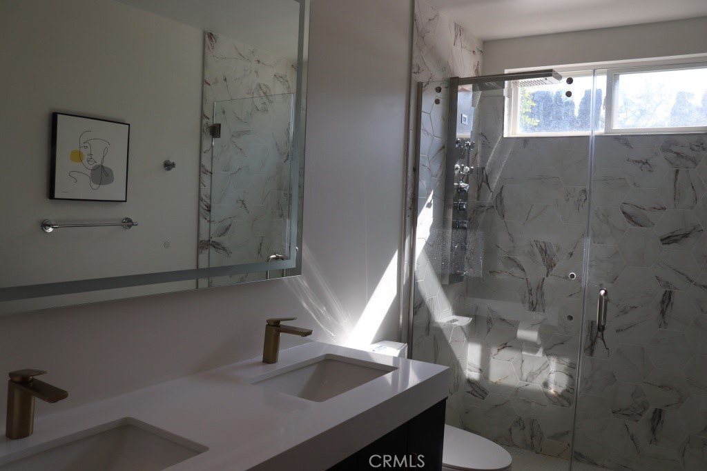 9103 Wystone Avenue Northridge, CA 91324 - Photo 23 of 59 a bathroom with a sink and a mirror