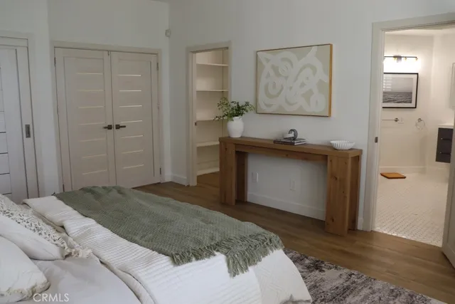 a large bed sitting in a bedroom next to a window