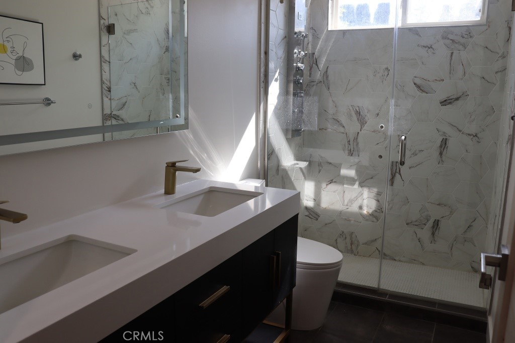 9103 Wystone Avenue Northridge, CA 91324 - Photo 36 of 59 a bathroom with a sink and mirror