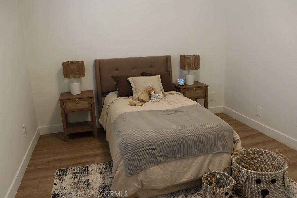 9103 Wystone Avenue Northridge, CA 91324 - Photo 37 of 59 a bed sitting in a bedroom next to a window and potted plant on a table
