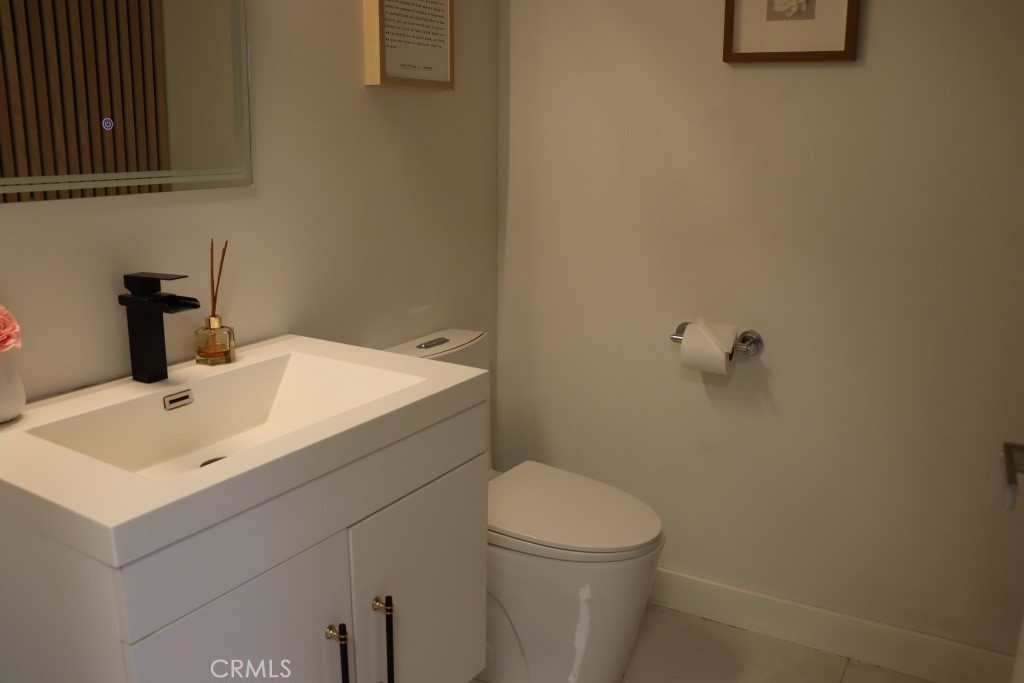 9103 Wystone Avenue Northridge, CA 91324 - Photo 39 of 59 a bathroom with a sink mirror and toilet