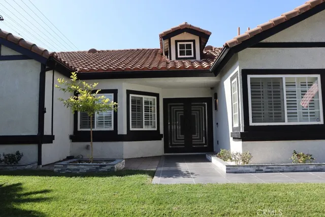 a front view of a house with garden