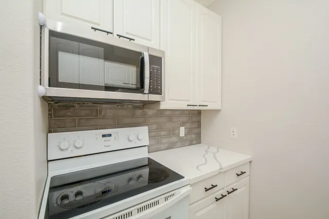 a kitchen with a stove and a microwave