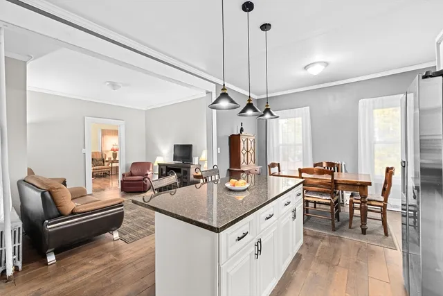 a view of a kitchen counter space dining table furniture and a chandelier