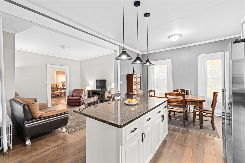 168 Spring Street Hanson, MA 02341 - Photo 17 of 40 a view of a kitchen counter space dining table furniture and a chandelier