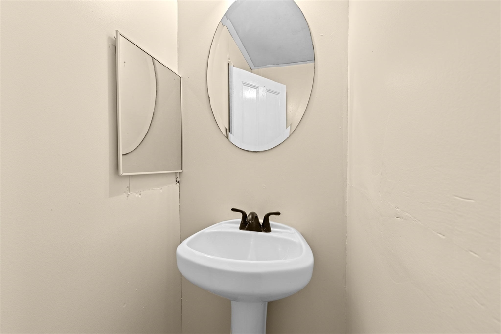 168 Spring Street Hanson, MA 02341 - Photo 18 of 40 a bathroom with a sink a mirror and a lamp