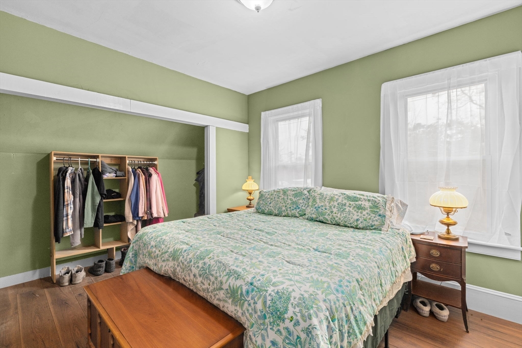 168 Spring Street Hanson, MA 02341 - Photo 22 of 40 a bedroom with a bed and a lamp on table