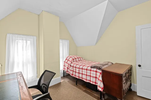 a bedroom with a bed and chair