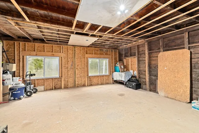 a view of a room with furniture and large windows