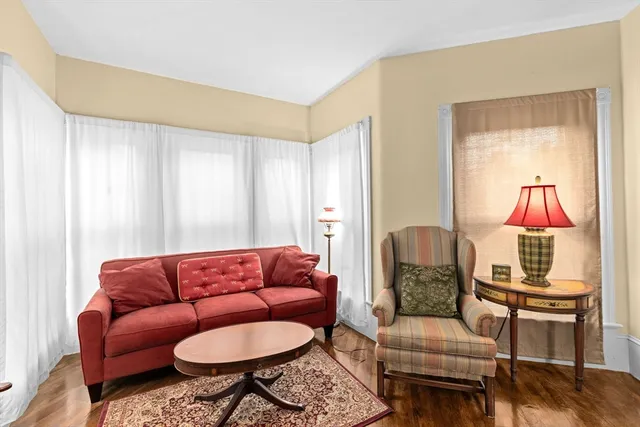a living room with furniture a rug and a window