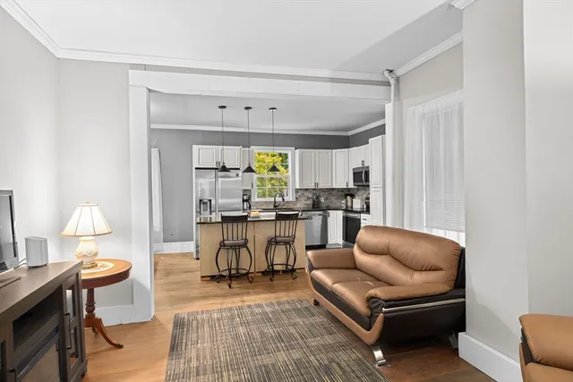 a living room with furniture a rug and a chandelier