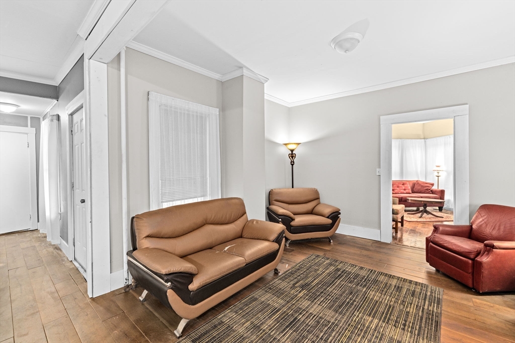 168 Spring Street Hanson, MA 02341 - Photo 10 of 40 a living room with furniture a lamp and a rug