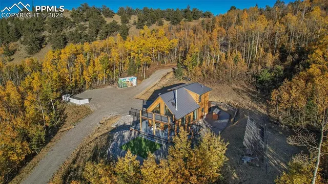a kitchen with a table chairs and a wooden floor