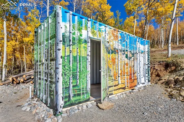 a view of a room with wooden floor and windows