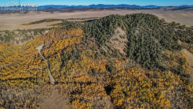 a view of a balcony with wooden floor and iron stairs
