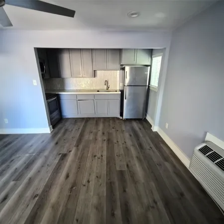 a kitchen with stainless steel appliances a refrigerator and a sink