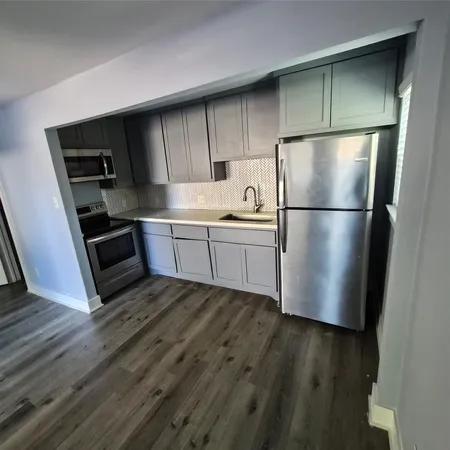 a kitchen with a refrigerator sink and microwave