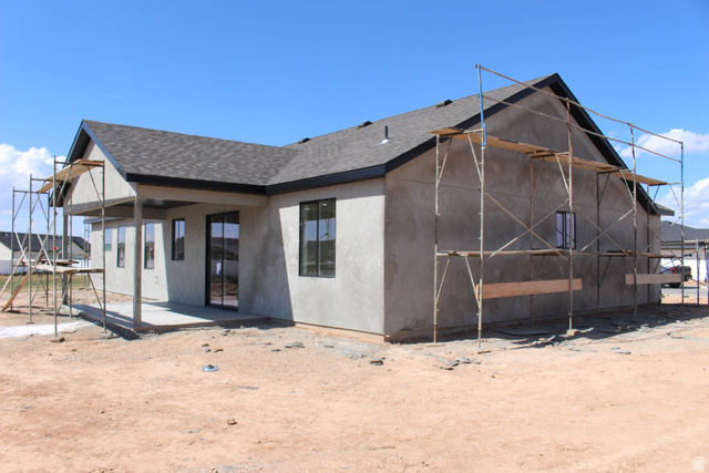 4933 East Remington Road Cedar City, UT 84721 - Photo 28 of 33 New construction property featuring a covered patio, dark shingle roof, and multiple large windows
