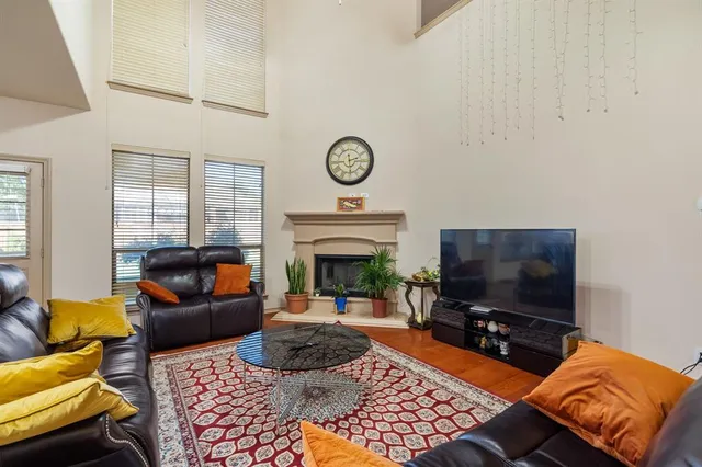 a living room with furniture a flat screen tv and a fireplace
