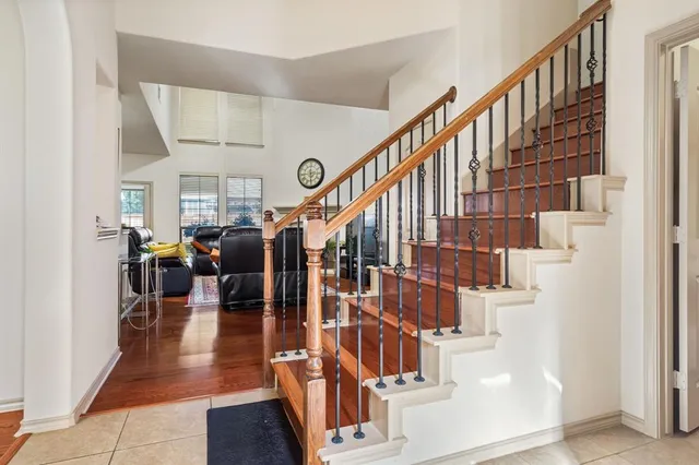 a view of entryway and hall with wooden floor