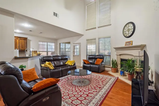 a living room with furniture a fireplace and a clock