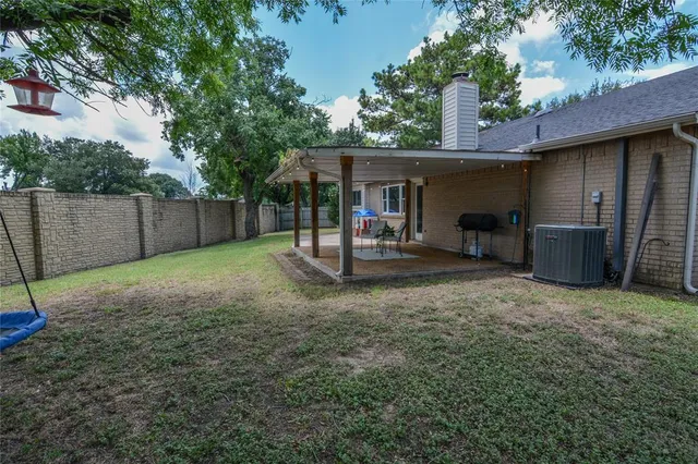 a view of a backyard with a cabin and a large tree