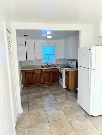 a kitchen with stainless steel appliances granite countertop a refrigerator and a stove