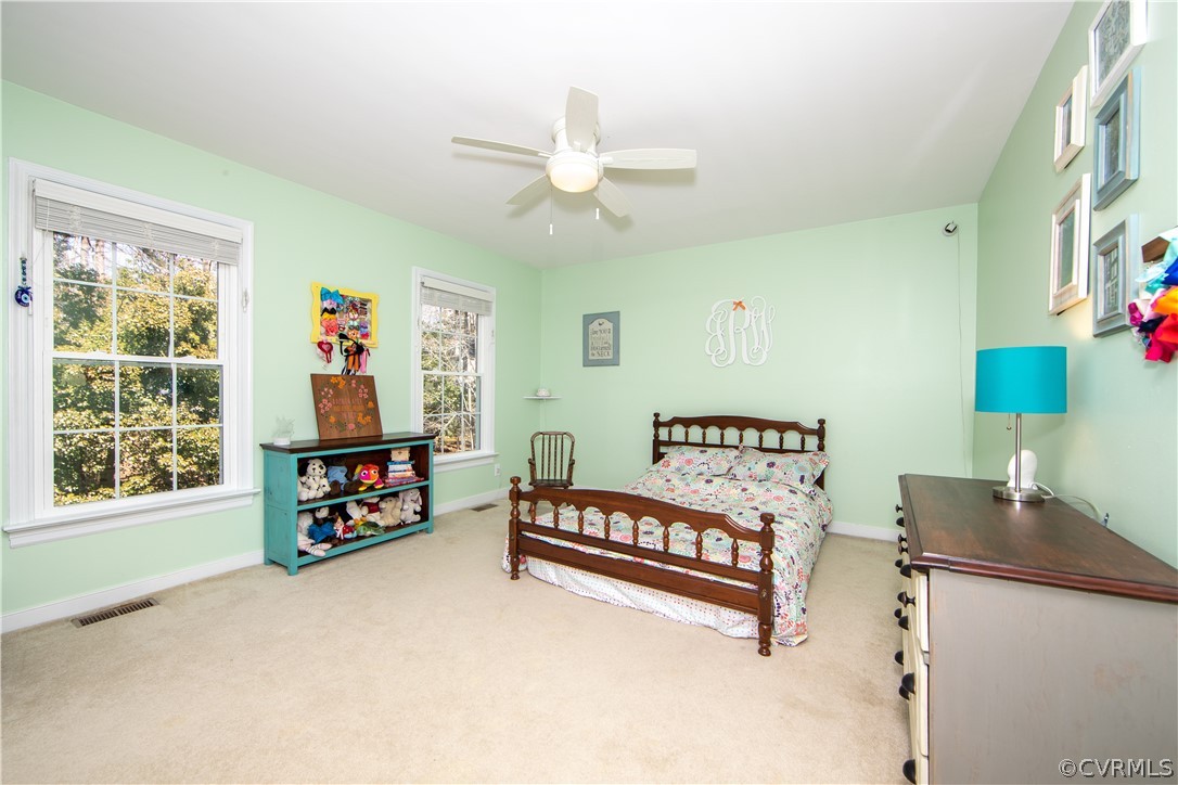 6212 Lansgate Road Midlothian, VA 23112 - Photo 18 of 26 a living room with furniture a baby crib and a window