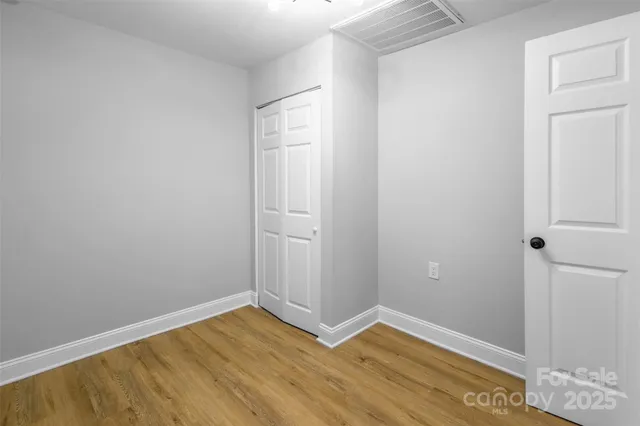 a view of a big room with wooden floor and closet