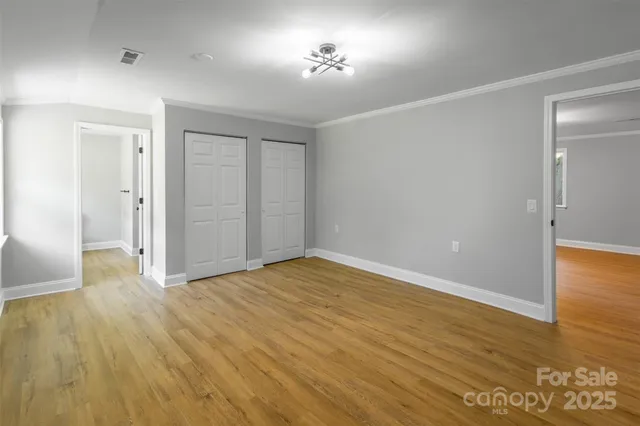 a bathroom with a granite countertop sink mirror vanity and toilet