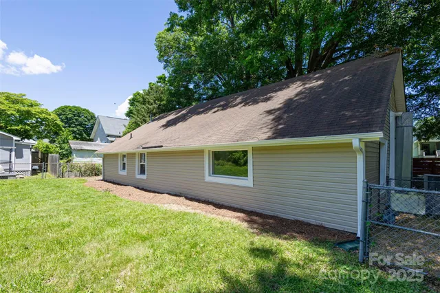 a view of a house with a tree in front of it