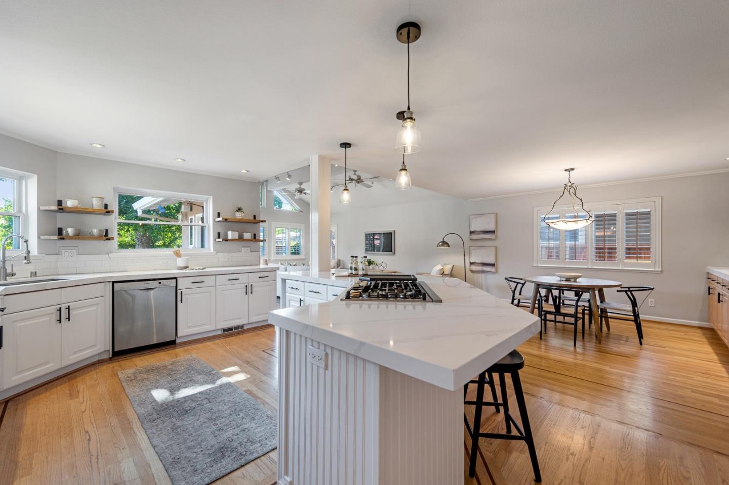851 Almarida Drive Campbell, CA 95008 - Photo 16 of 63 a kitchen with stainless steel appliances kitchen island granite countertop a stove a sink a dining table and chairs with wooden floor