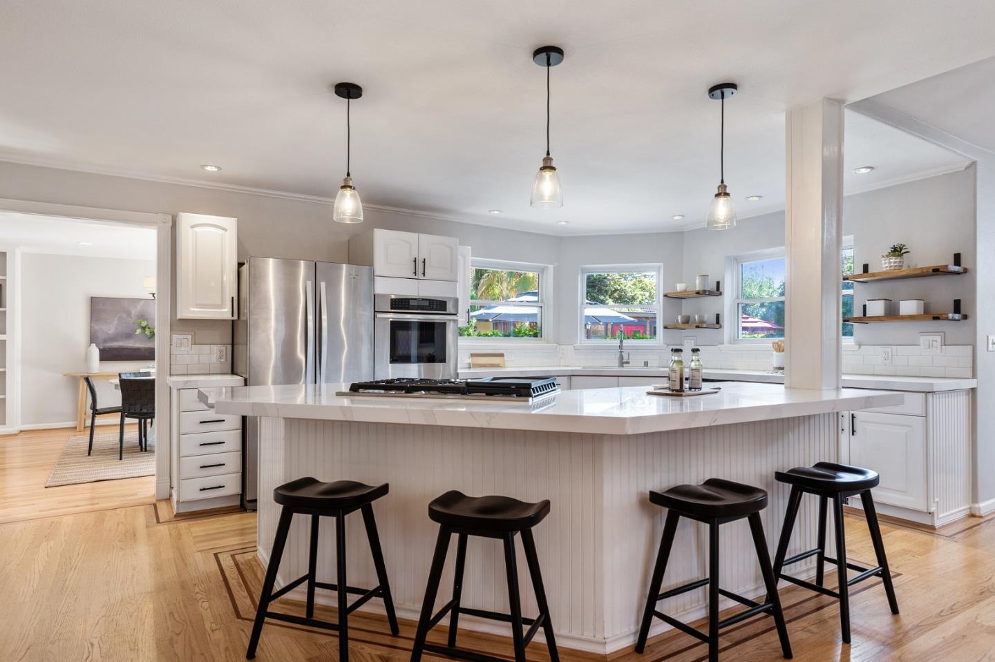 851 Almarida Drive Campbell, CA 95008 - Photo 17 of 63 a kitchen with stainless steel appliances a dining table chairs and white cabinets