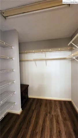a view of a room with wooden floor and cabinets