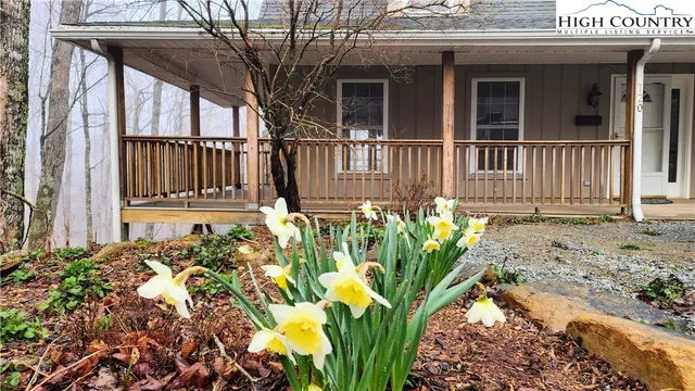 a view of a house with a flower garden