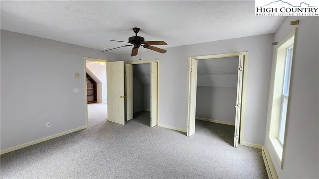 a view of empty room with ceiling fan