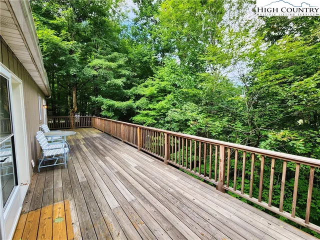 a view of balcony with wooden floor and fence