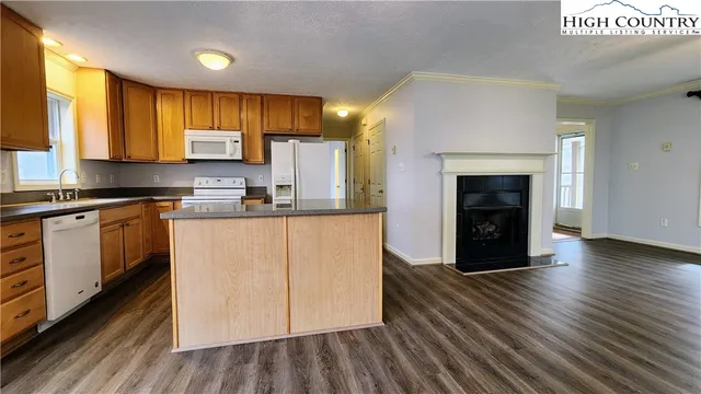 a kitchen with kitchen island a sink cabinets and wooden floor