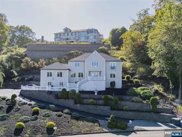 a front view of a house with a yard and a sitting area